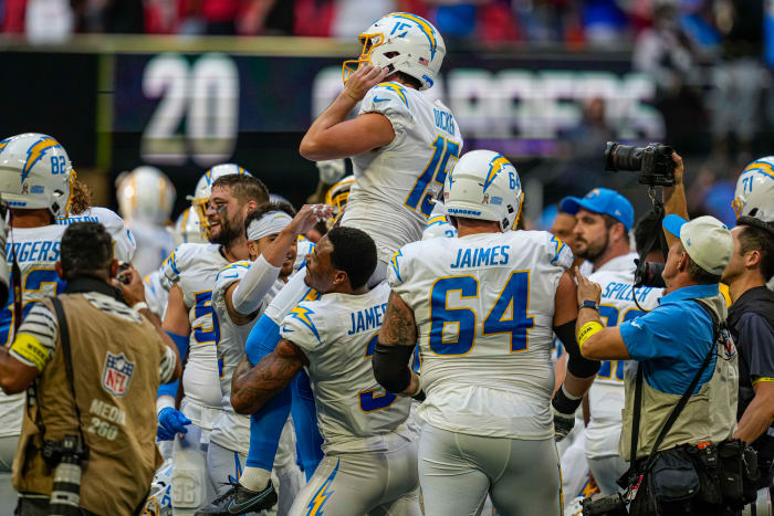 Chargers players lift kicker Cameron Dicker on their shoulders after a game-winning kick to beat the Falcons